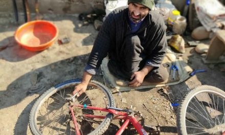 With paralyzed legs, Pulwama man starts cycle repairing to earn livelihood
