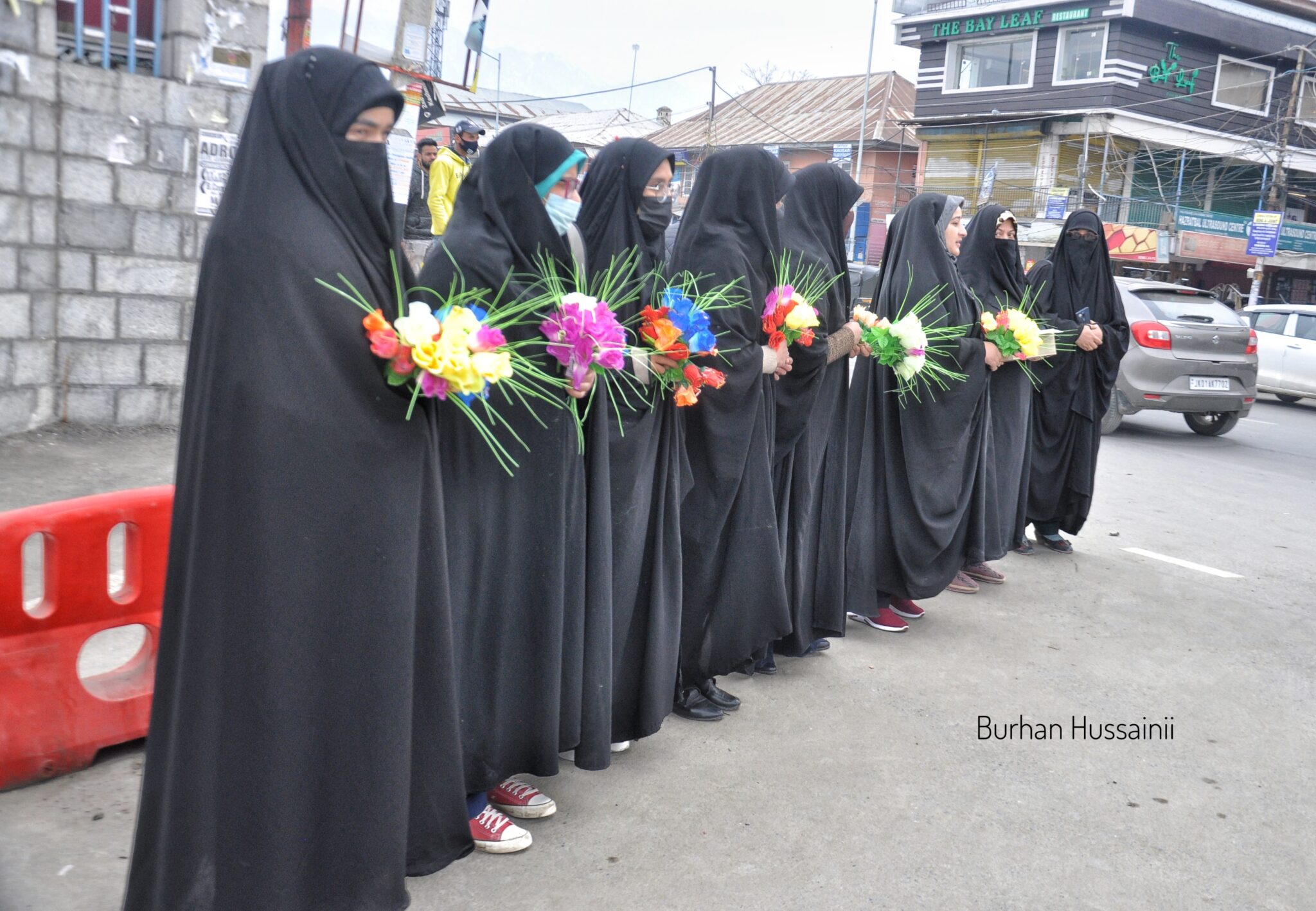 Ladies offer flowers to hijab-clad students outside Kashmir University